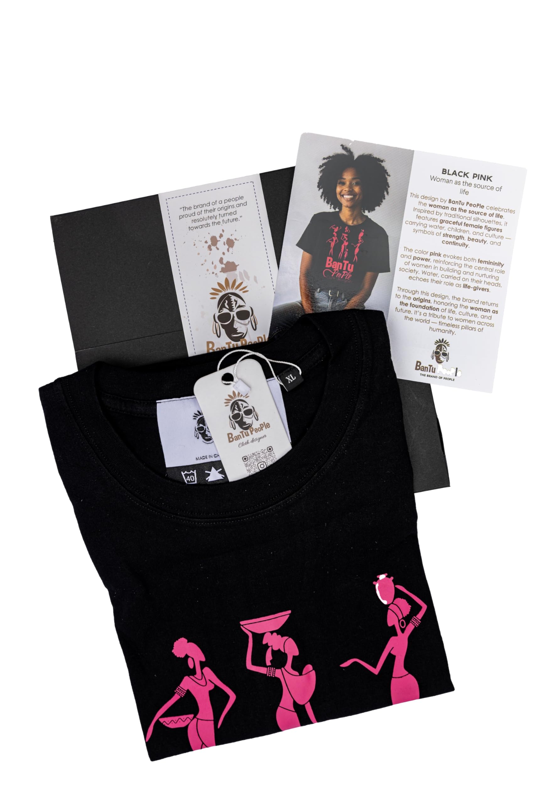 Black t-shirt with pink graphics, packaging, and tags on a white background